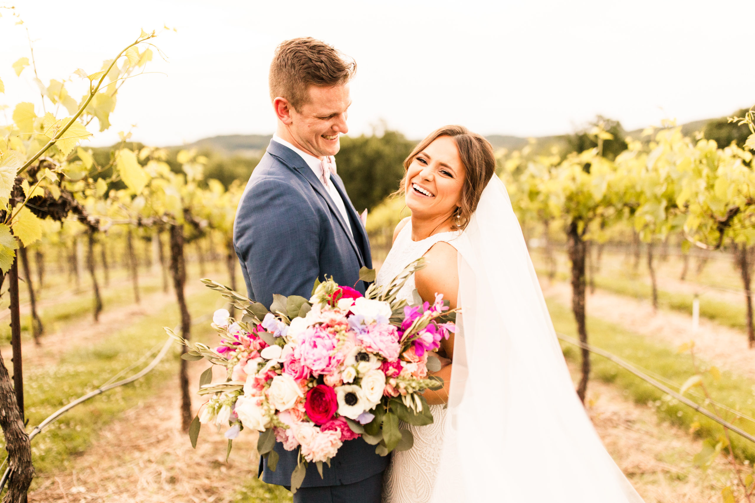 bride and groom with flower at vineyard wedding