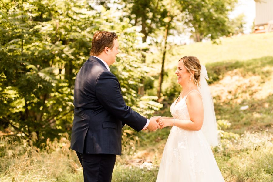 bride and groom share a joyful first look