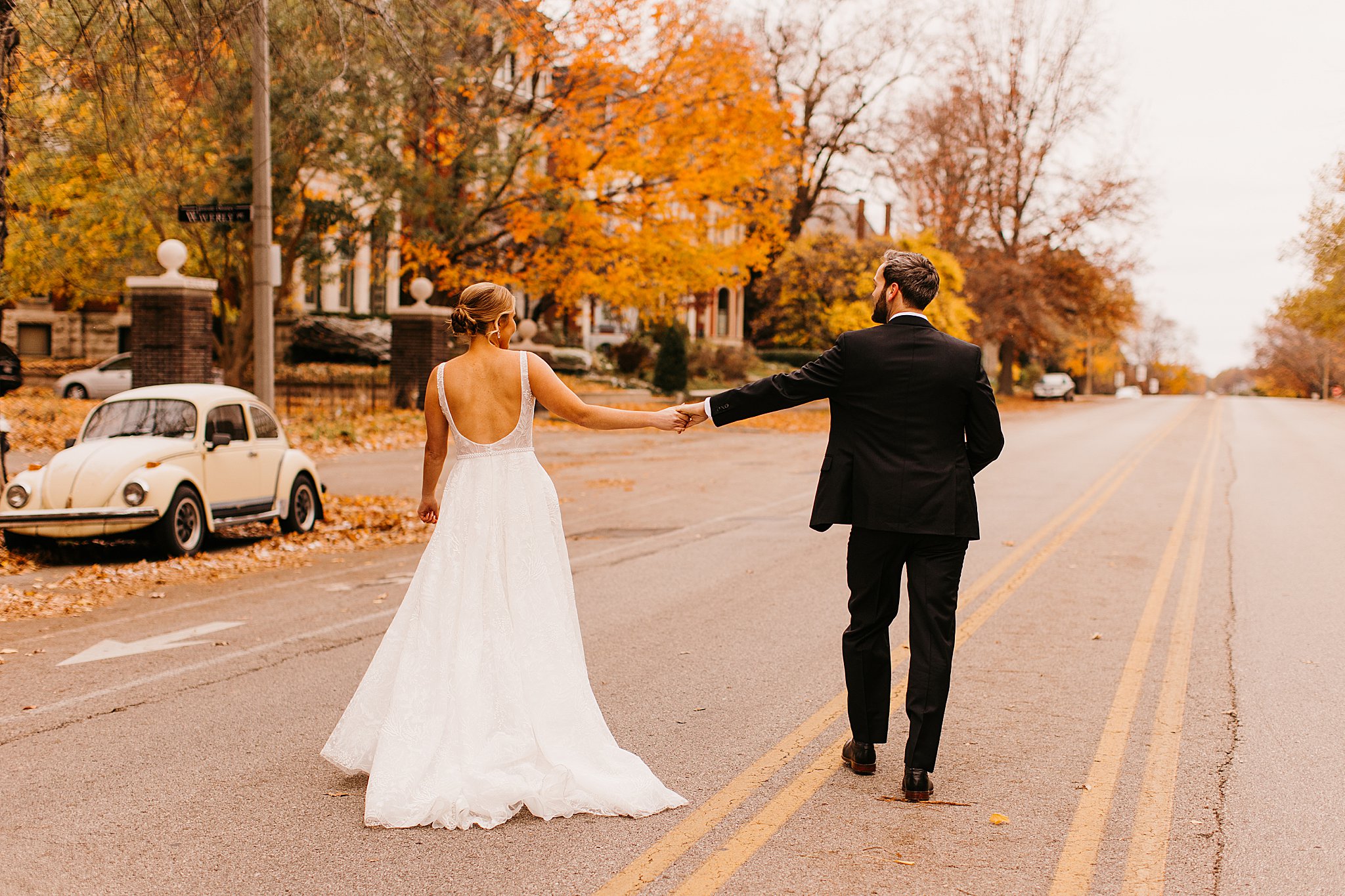 Bride and Groom walking through Lafayette Square in the fall